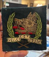 Front view of square embroidered patch showing full design, motto banner, date 1901