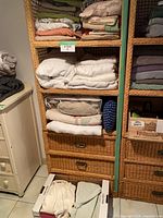 Shelving unit showing folded sheets, mattress covers, blankets and packaged quilt