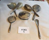 All seven Birks sterling vanity items laid out