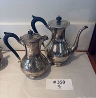 Two Birks sterling coffee pots side by side