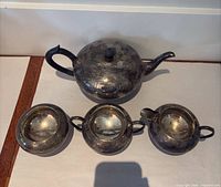 Full view of teapot and three matching pieces