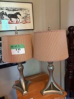 Front view of both brushed nickel lamps with striped shades