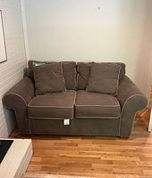 Front view of loveseat showing cushions, piping, overall condition