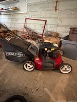 Full left side view showing mower, red deck, rear bagger