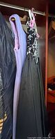 Lavender and black gowns hanging in closet