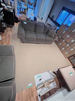 Full room view showing the 10x12 beige loop pile rug on hardwood floor