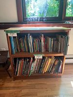 Front view of bookcase showing two tiers with books for scale