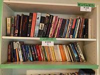 Two shelves filled with approximately 65 assorted novels and classics.