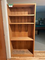 Front view of oak bookcase showing overall structure and shelves