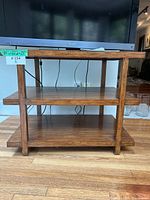 Front view of three-tier wooden shelving unit