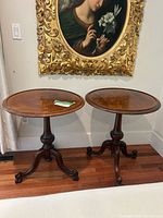 Full view of both matching Victorian-style round side tables