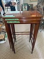 Set of three wooden nesting tables stacked together