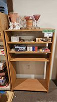 Front view of wood shelving unit with three adjustable shelves