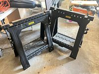Two Stanley folding saw horses standing side by side