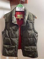 Front view olive green quilted vest red lining visible