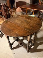 Overall view of oak gateleg table with leaves down showing turned legs