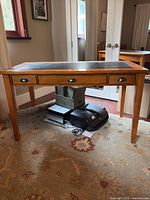 Front view showing full desk, drawers, and legs