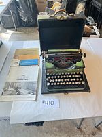 Full view of Royal Model P typewriter in case with three brochures laid alongside