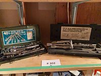 Both socket sets open in cases showing sockets and ratchets