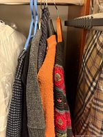 Group of knits on hangers showing various colours and textures
