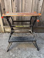 Front view of entire Black & Decker Workmate showing wooden jaws, frame and step platform