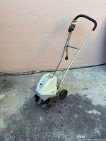 Full view of electric tiller standing upright