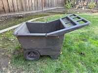 Side view of entire plastic garden cart on lawn