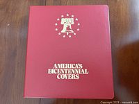 Front cover of red binder titled America’s Bicentennial Covers with Liberty Bell graphic