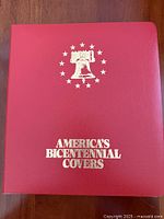 Front cover of red binder showing title and emblem