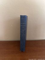 Spine view of blue cloth hardcover book with title and author