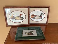 Two framed duck decoy prints and Otagiri tray on tabletop