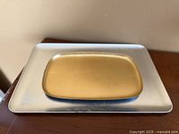 Gold tray on top of silver tray showing sizes and colors