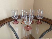Five matching glasses on table showing full shape and quantity
