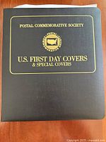 Front of black binder showing gold title