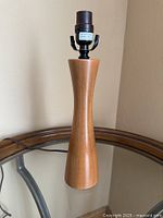 Full view of teak lamp showing base, socket and cord