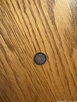 Reverse side of 1901 Canada 5-cent coin on wood surface