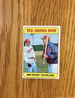 Front of 1969 Topps card showing Ted Williams instructing Mike Epstein, yellow border, title and names visible