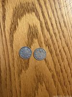 Both 1909 Canadian dimes reverse sides