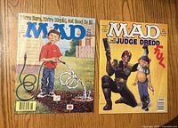 Front covers of both MAD magazines showing issue themes