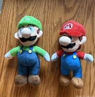 Front view of Luigi and Mario plush figures