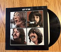 Front cover of Let It Be album and vinyl partially visible