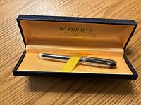Fountain pen resting in open Waterman box