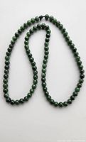 Full view of green jade bead necklace looped