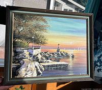 front view of framed painting depicting waterfront scene