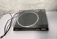 Full view of Technics turntable with dust cover and cables