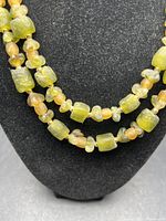 Close-up of green Roman glass beads showing shape and texture