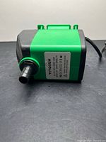 Side view of pump showing outlet and label