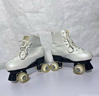 Full view of both skates showing boots, plates and wheels