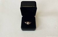 ring centered in open velvet box, front view