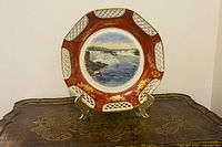 Front view of plate showing Niagara Falls scene and red gilt reticulated border